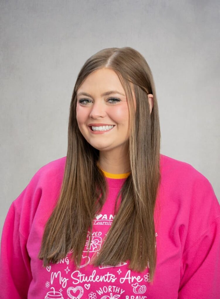 Portrait Of A Smiling Team Member In A Pink Shirt