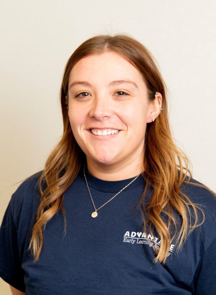 Portrait Of A Smiling Team Member In A Navy Advantage Shirt