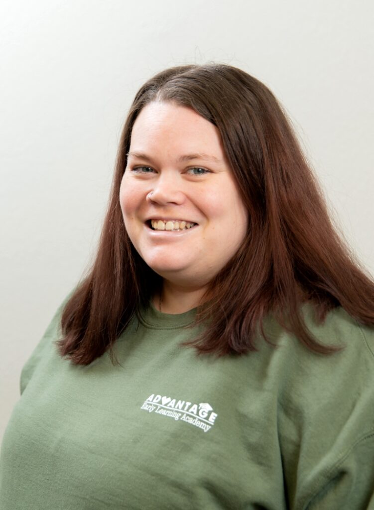 Portrait Of A Smiling Team Member In A Green Advantage Shirt