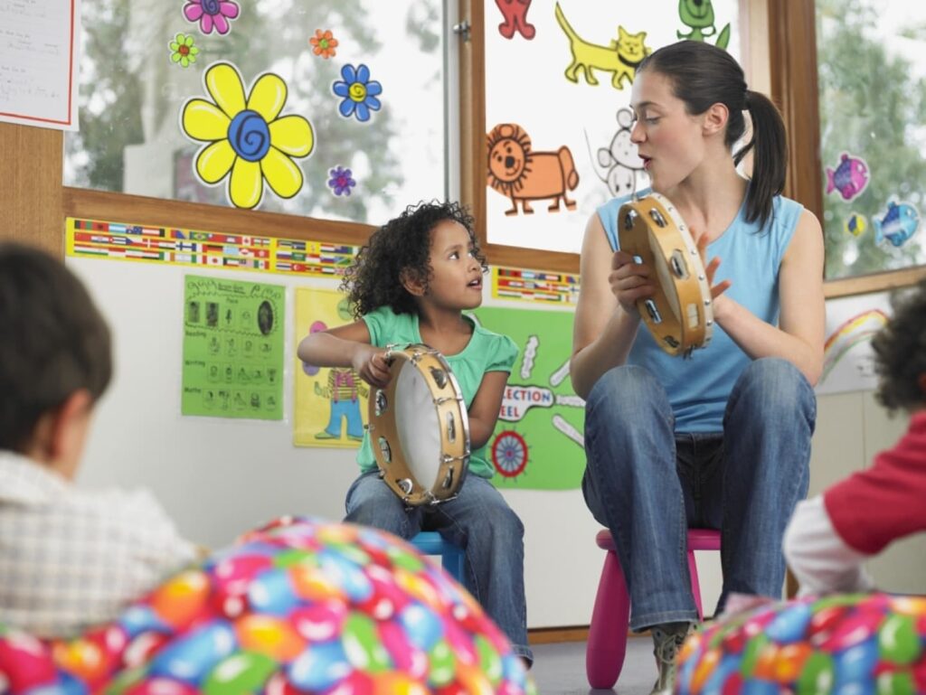 Teacher Reading A Picture Book To A Group Of Children